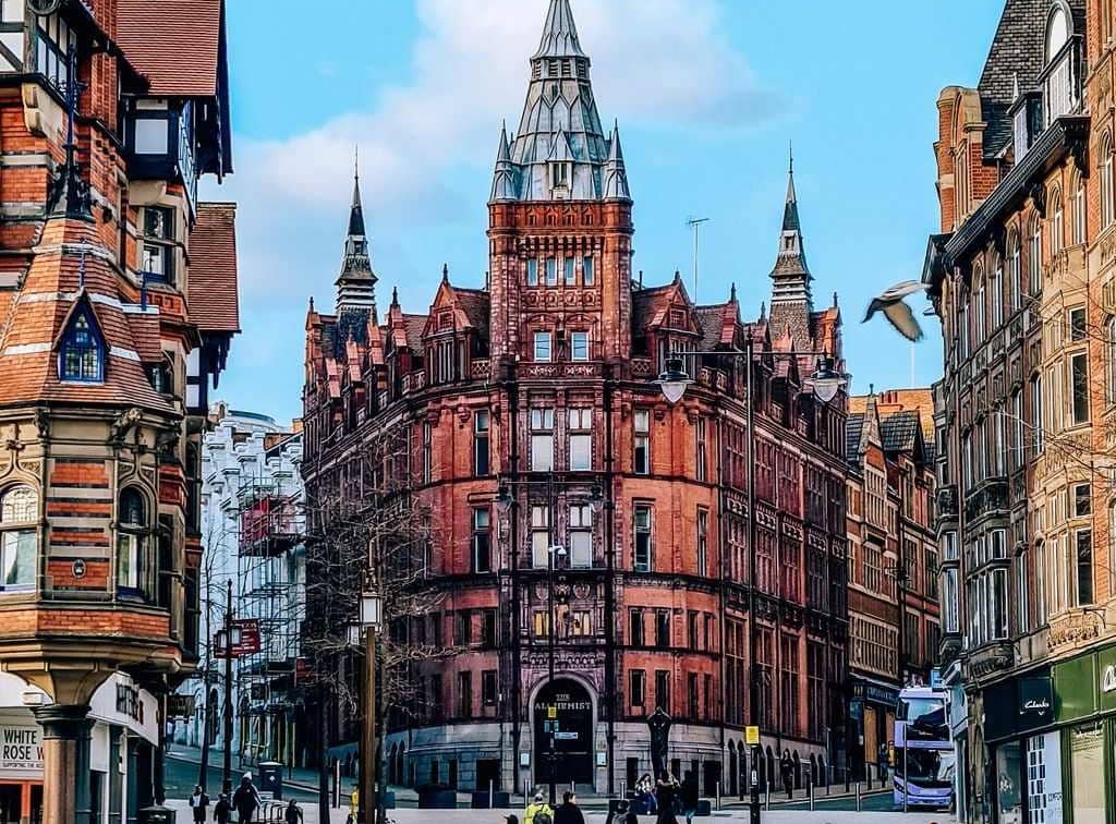 A large brick building with many windows in the centre of Nottingham's street on a day trip from Birmingham